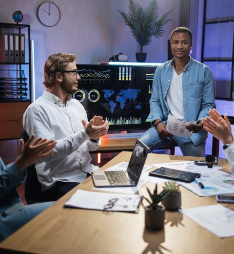 African man presenting financial report to diverse partners